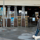 man walking dog in front of restaurant